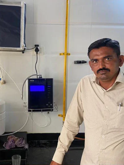 Male user quenching his thirst using the Chanson Quality Water Purifier