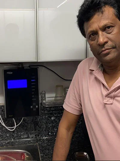 Man showcasing the convenience of using Chanson Quality Water Purifier