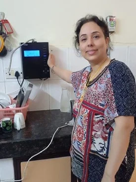 female enjoying the ease of use of his Chanson Quality Water Purifier