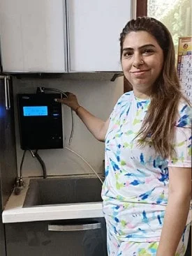 women relishing the taste of water from his Chanson Quality Water Purifier