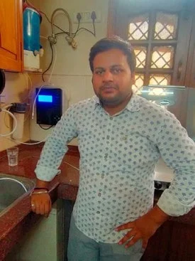 Male customer enjoying the efficiency of the Chanson Quality Water Purifier