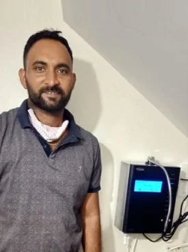 Man ensuring his water is clean with the Chanson Quality Purifier