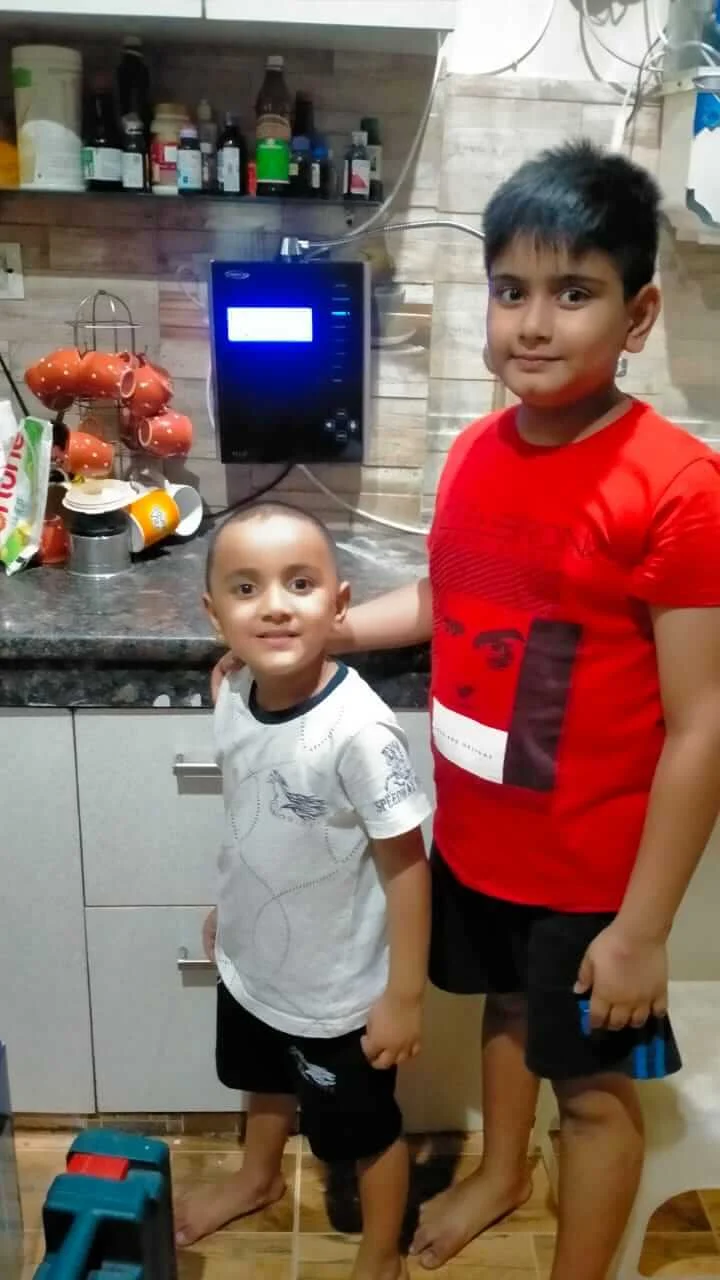 Kid standing with the reliable Chanson Quality Water Purifier