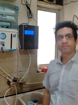 Man relishing the taste of water from his Chanson Quality Water Purifier