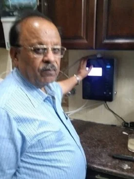 Man quenching thirst with water from the Chanson Quality Purifier