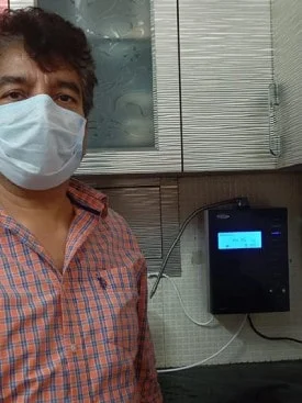 Chanson Quality Water Purifier serving a satisfied male customer