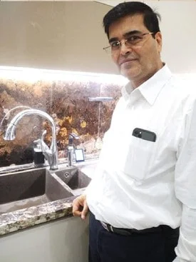 Male enjoying pure, fresh water from his Chanson Quality Water Purifier