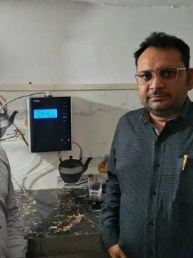 Male taking a water break with his Chanson Quality Water Purifier