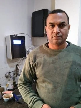 Man assured of his water's purity with the Chanson Quality Water Purifier