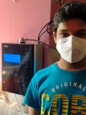 Man drinking purified water from his Chanson Quality Water Purifier