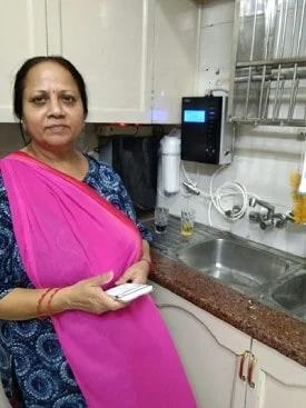 Satisfied woman with her Chanson Quality Water Purifier