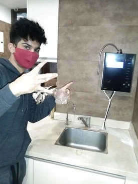 Man assured of his water's purity with the Chanson Quality Water Purifier