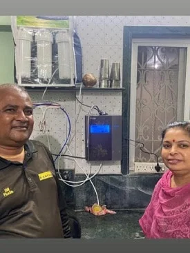 Man drinking purified water from his Chanson Quality Water Purifier