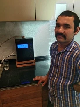 Male taking a water break with his Chanson Quality Water Purifier