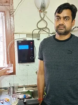 Man ensuring his water is clean with the Chanson Quality Purifier