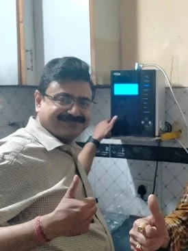 Male enjoying pure, fresh water from his Chanson Quality Water Purifier