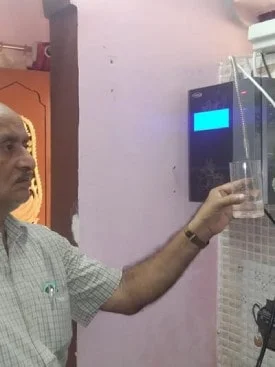 Man quenching thirst with water from the Chanson Quality Purifier