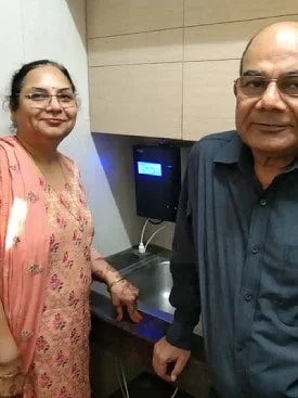 Male standing next to his trusted Chanson Quality Water Purifier