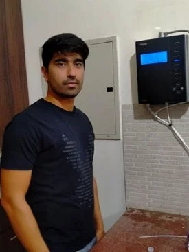 Man drinking purified water from his Chanson Quality Water Purifier