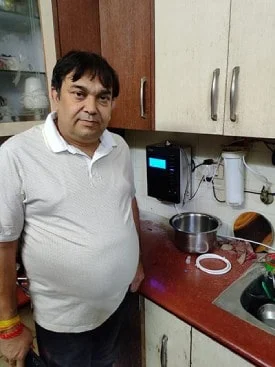 Chanson Quality Water Purifier being operated by a health-conscious man