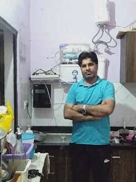 Man assured of his water's purity with the Chanson Quality Water Purifier