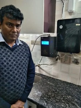 Man drinking purified water from his Chanson Quality Water Purifier
