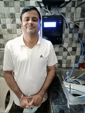 Individual with Chanson Quality Water Purifier demonstrating purified water