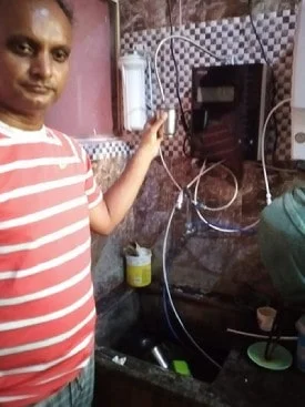 Male customer utilizing Chanson Quality Water Purifier for daily hydration