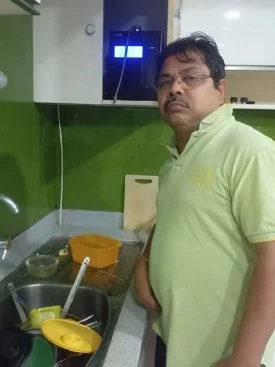 Man drinking purified water from his Chanson Quality Water Purifier
