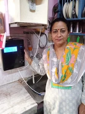 women user quenching his thirst using the Chanson Quality Water Purifier