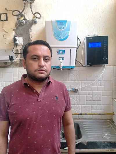 male customer happily engaged with the Chanson Quality Water Purifier