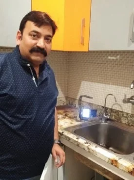 Man at home with his Chanson Quality Water Purifier