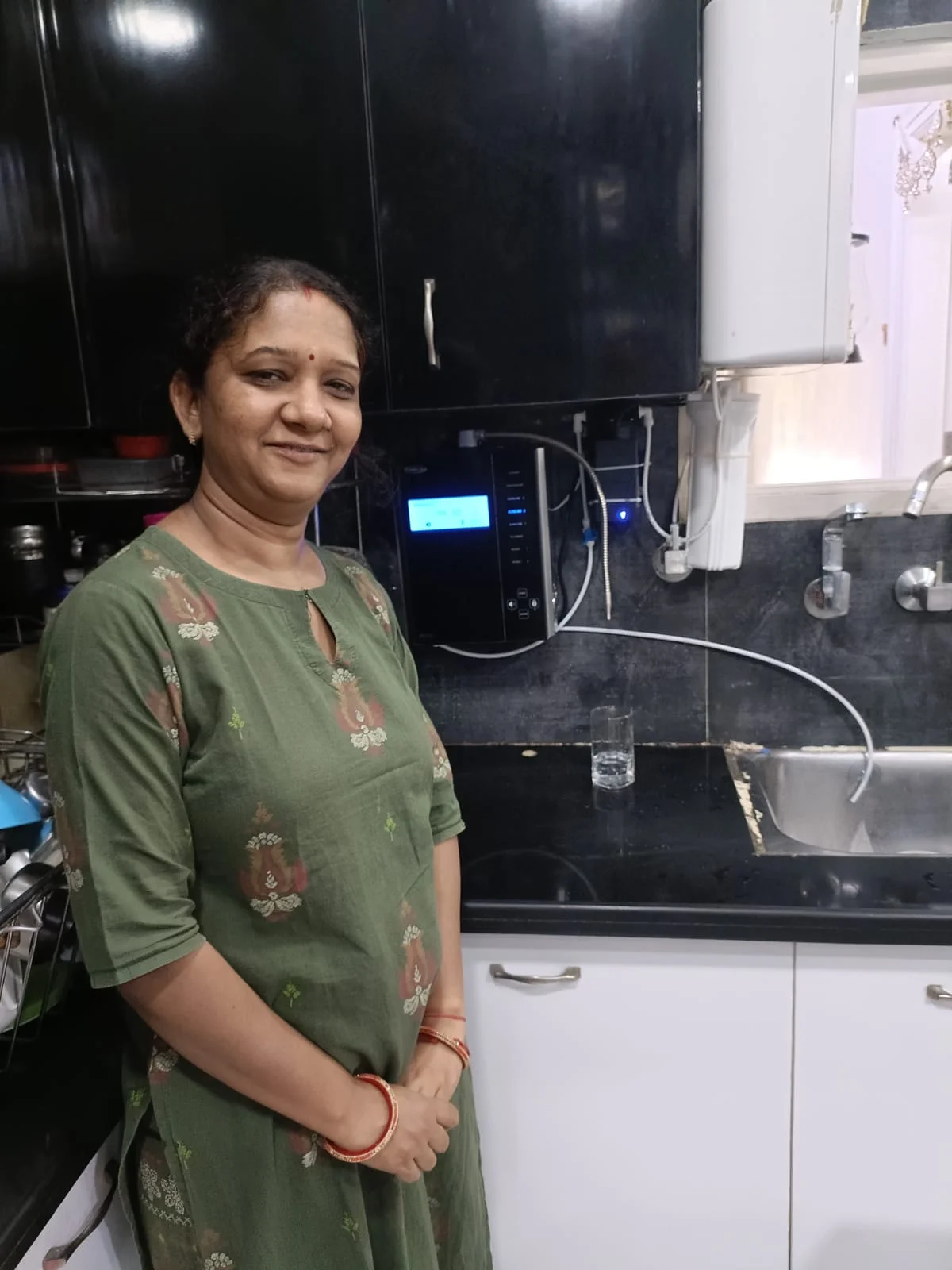 Chanson Quality Water Purifier being operated by a health-conscious women