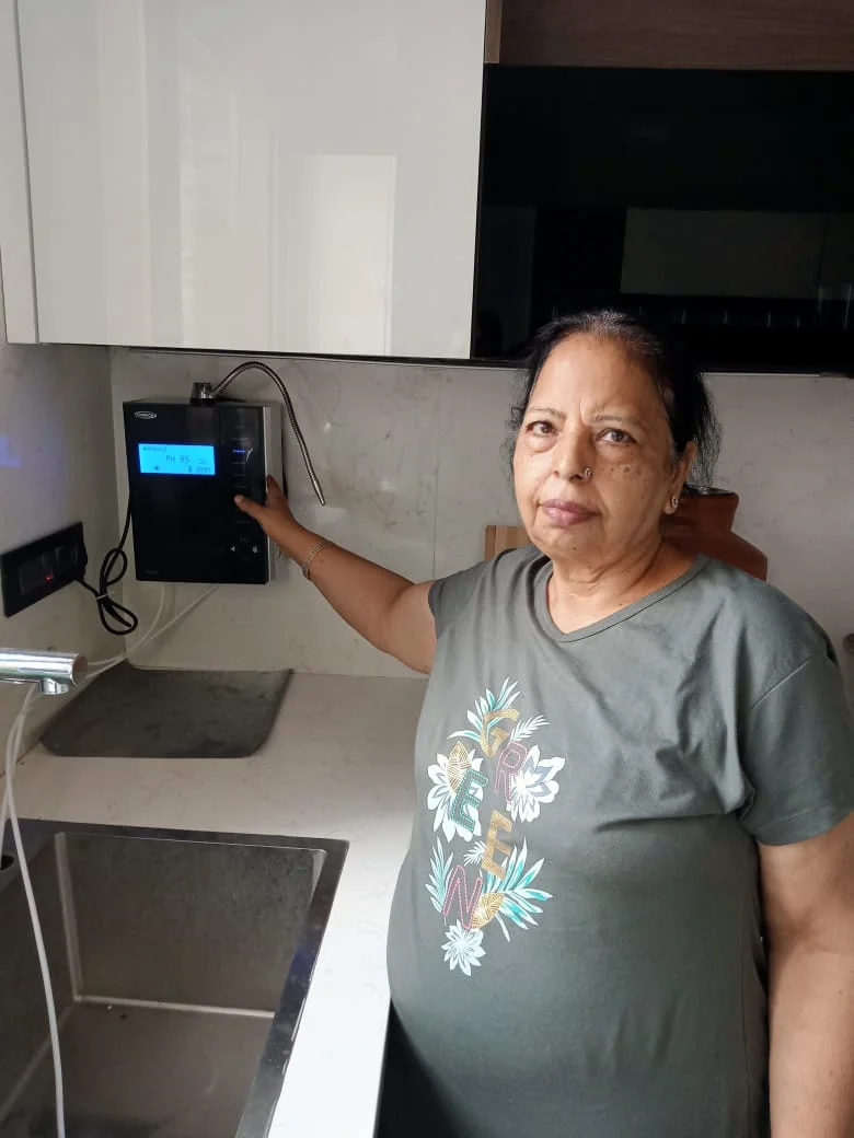 women standing next to his trusted Chanson Quality Water Purifier