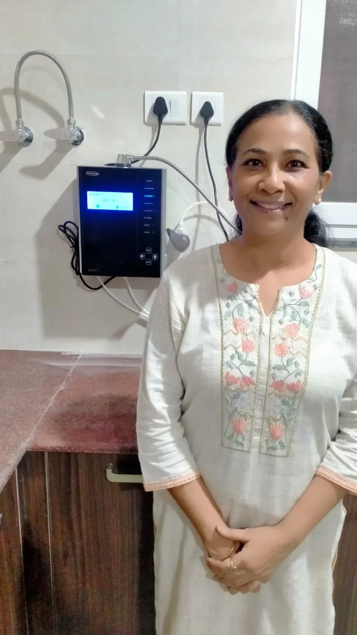 women standing next to his trusted Chanson Quality Water Purifier