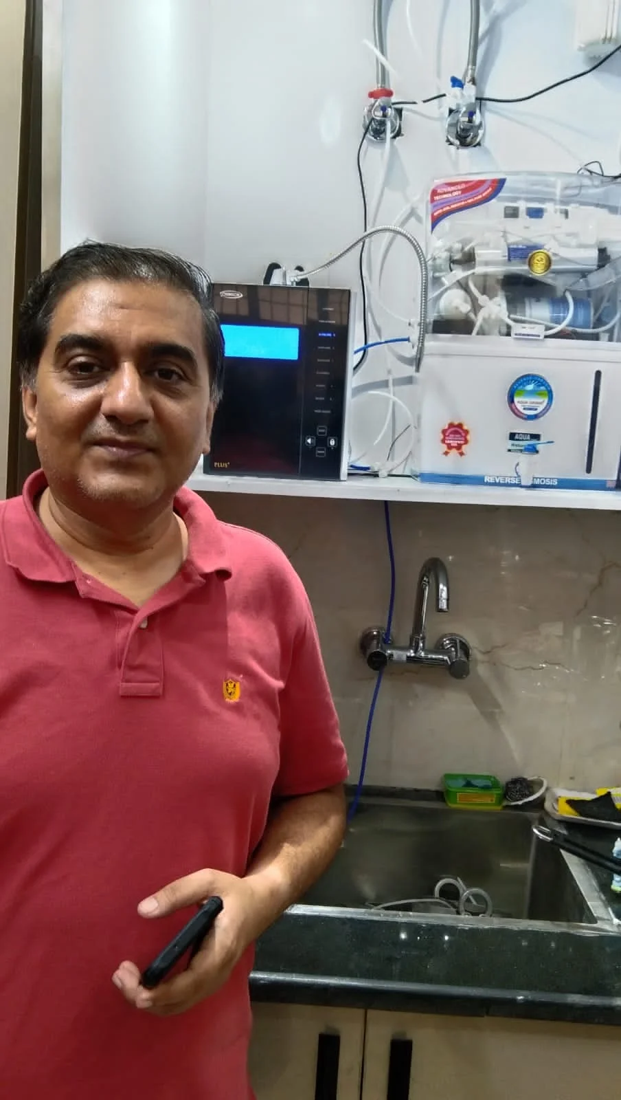 Male user quenching his thirst using the Chanson Quality Water Purifier