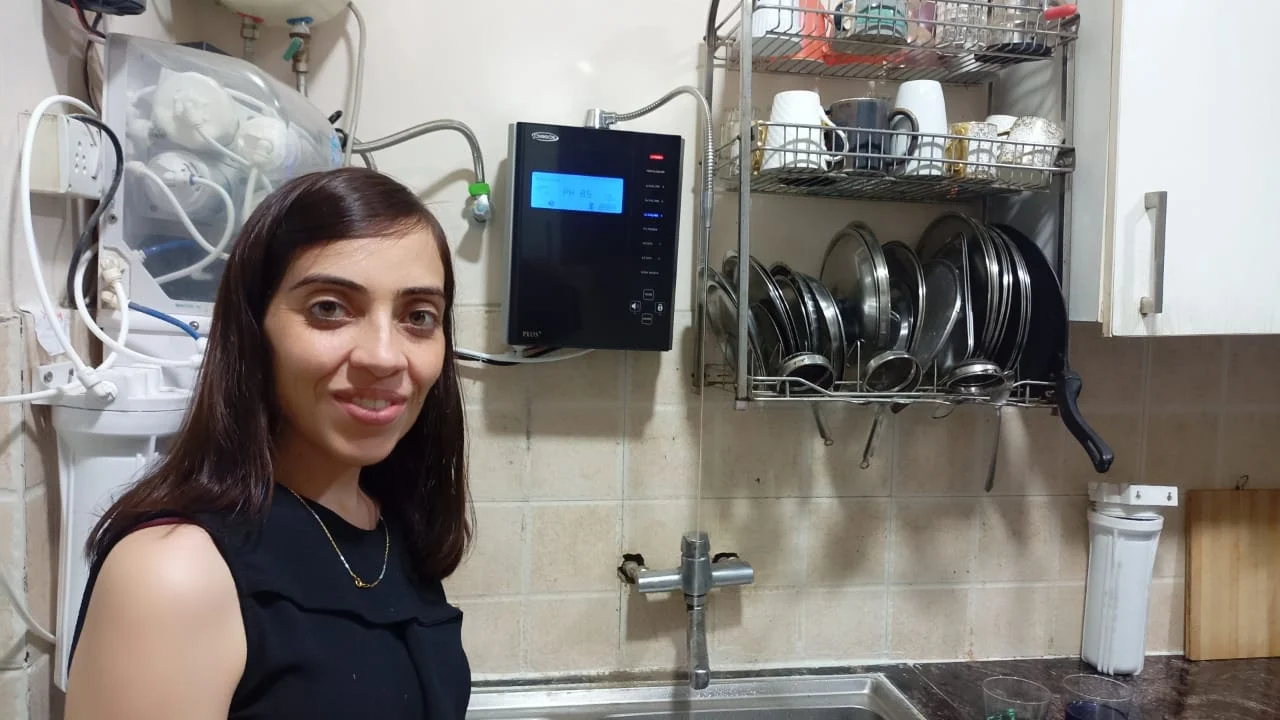 Individual standing with the top-rated Chanson Quality Water Purifier