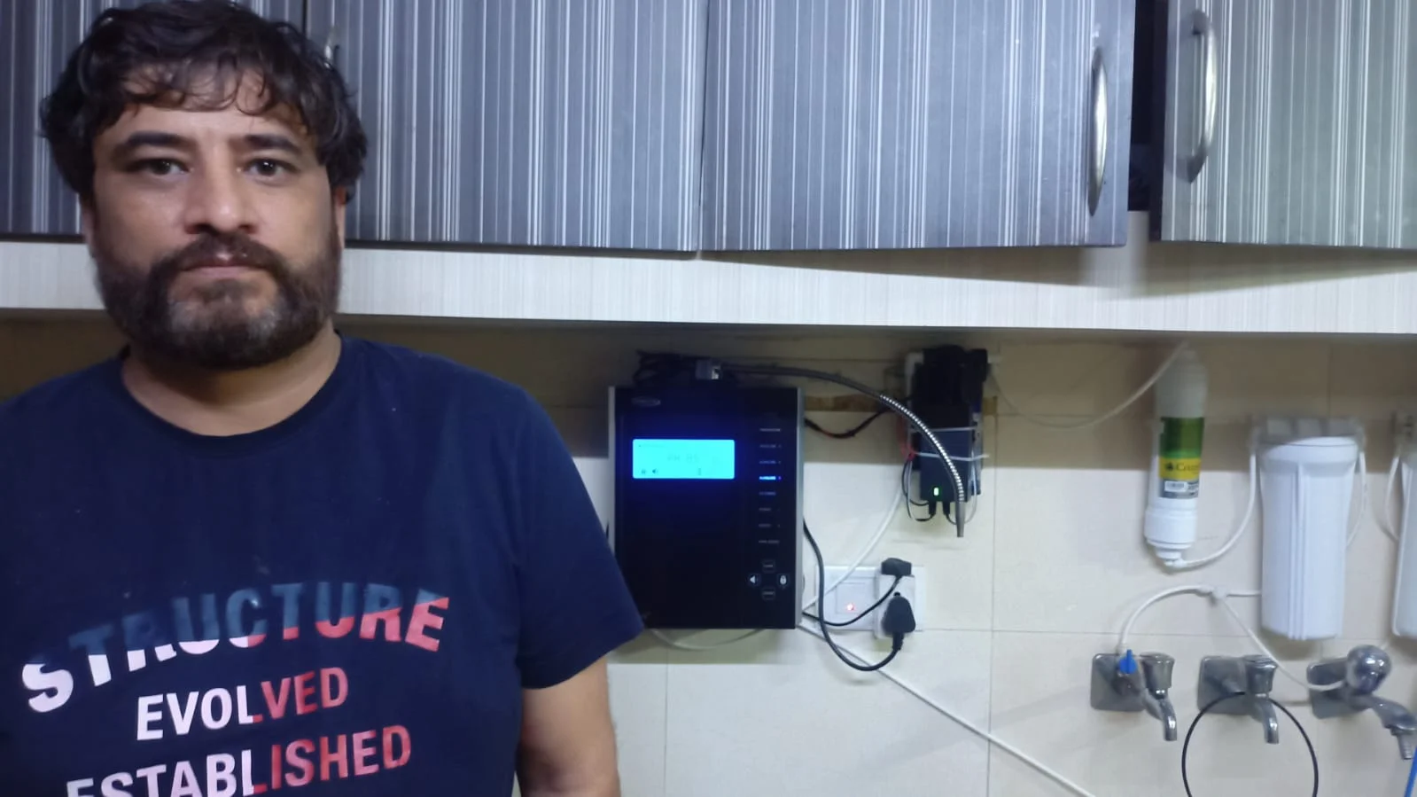 Male enjoying pure, fresh water from his Chanson Quality Water Purifier