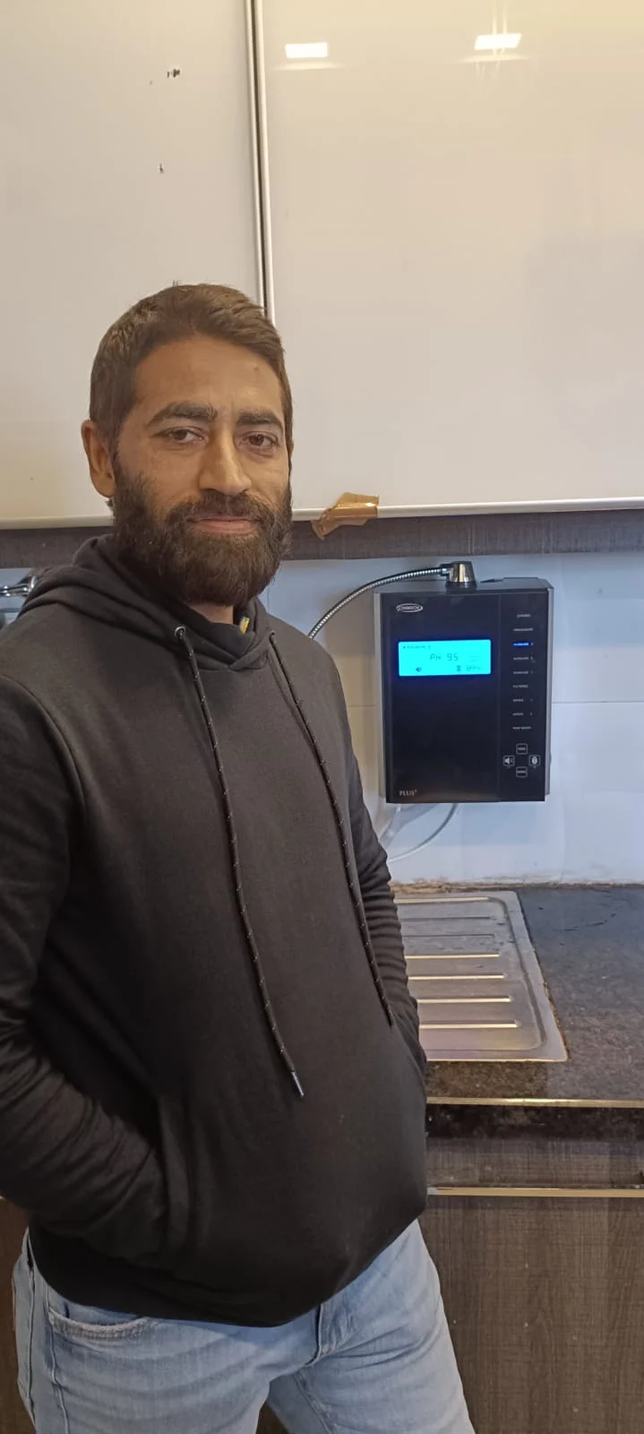 Male enjoying the ease of use of his Chanson Quality Water Purifier