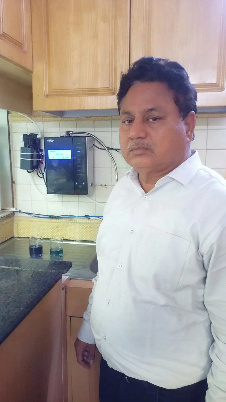 Male customer enjoying the efficiency of the Chanson Quality Water Purifier