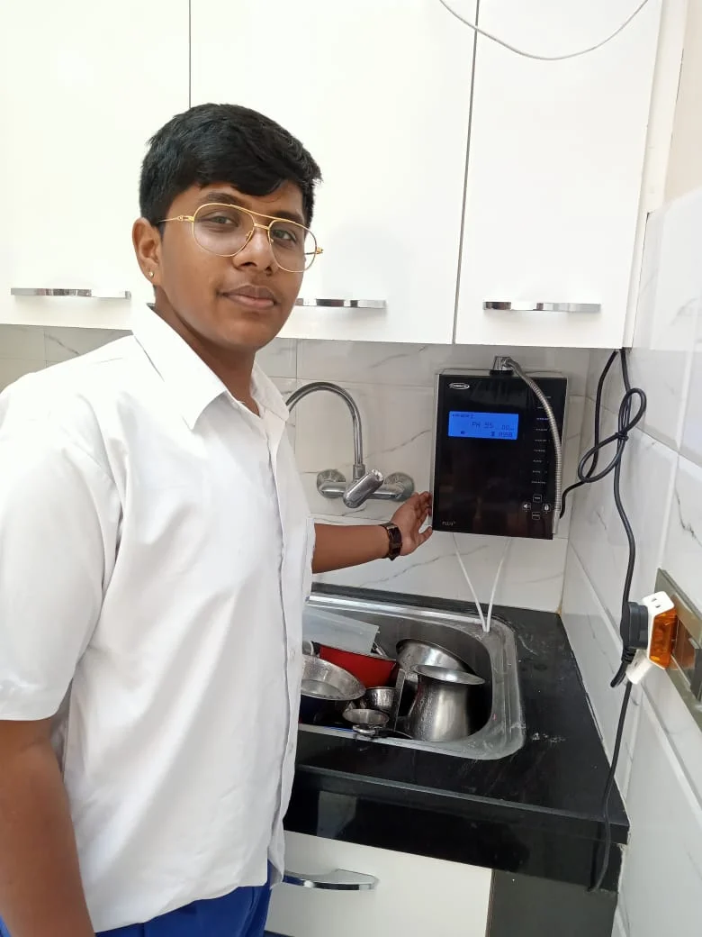 Man quenching thirst with water from the Chanson Quality Purifier