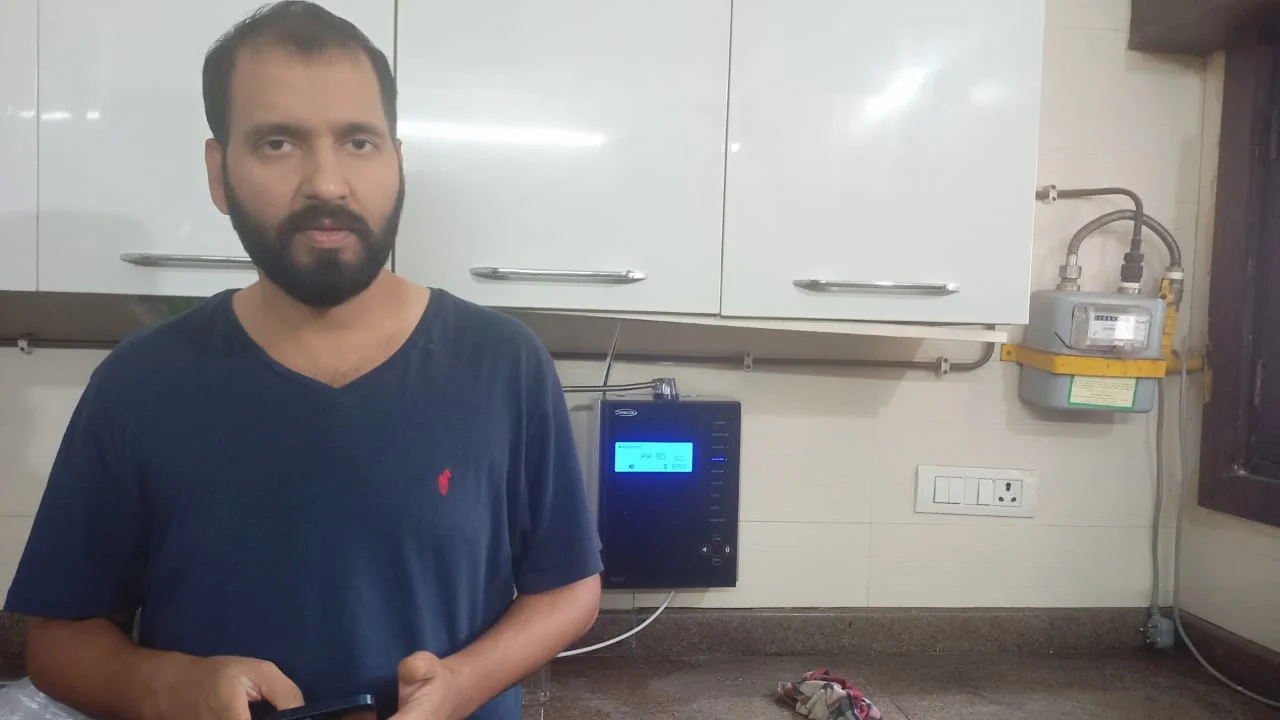 User operating Chanson Quality Water Purifier confidently