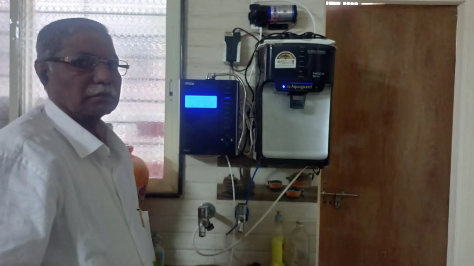 Man relishing the taste of water from his Chanson Quality Water Purifier