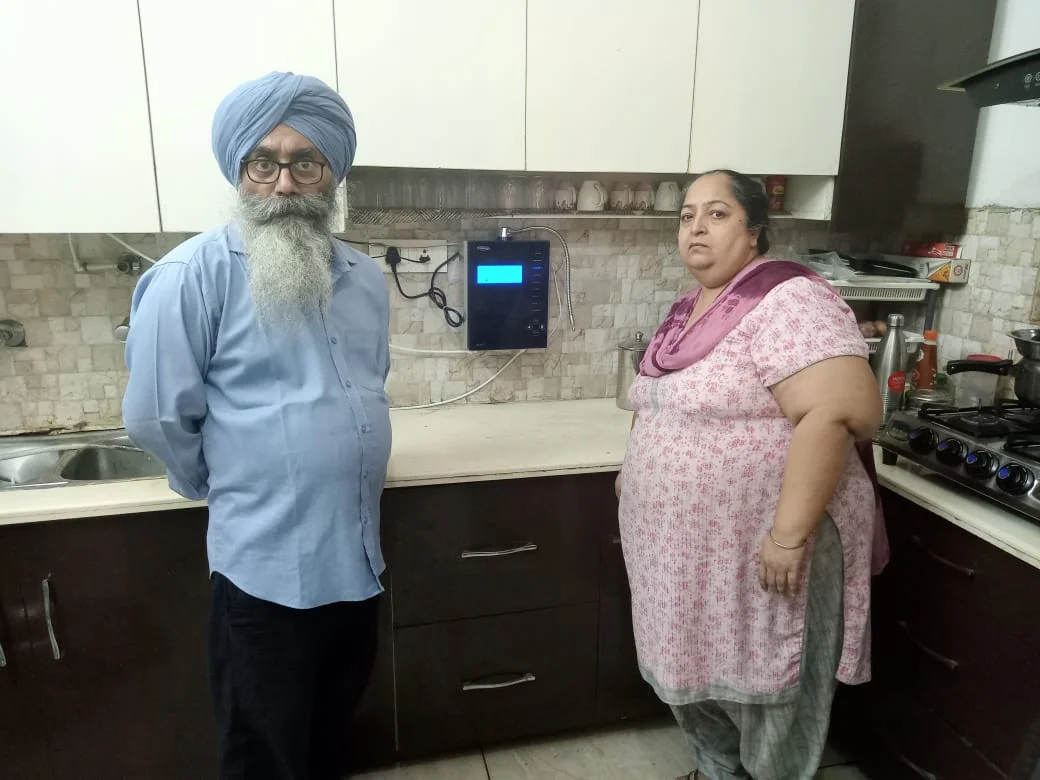 Male customer utilizing Chanson Quality Water Purifier for daily hydration